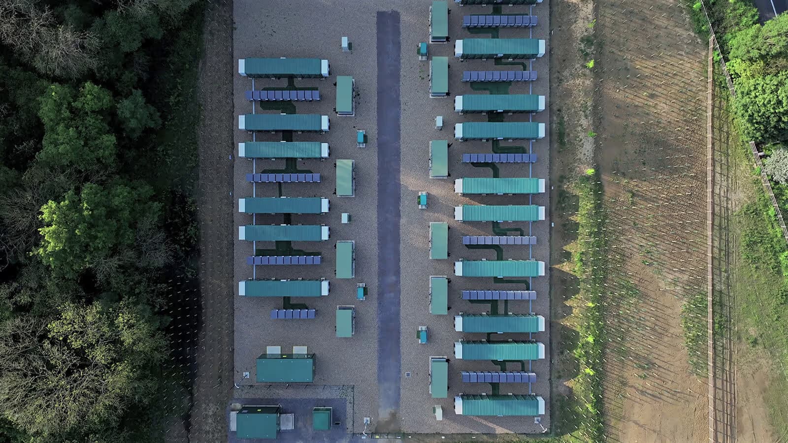 Aerial view of a battery storage park between fields and trees